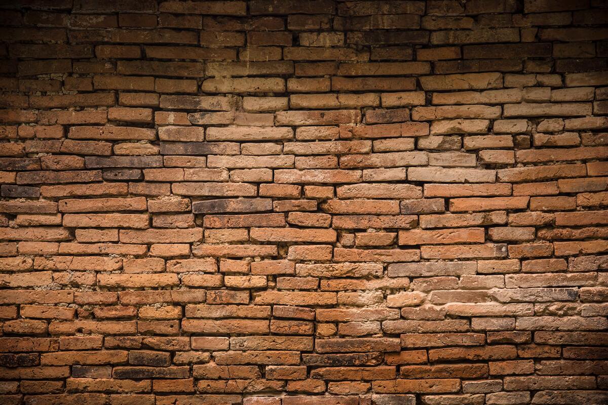Papier peint Un mur de briques qui plie