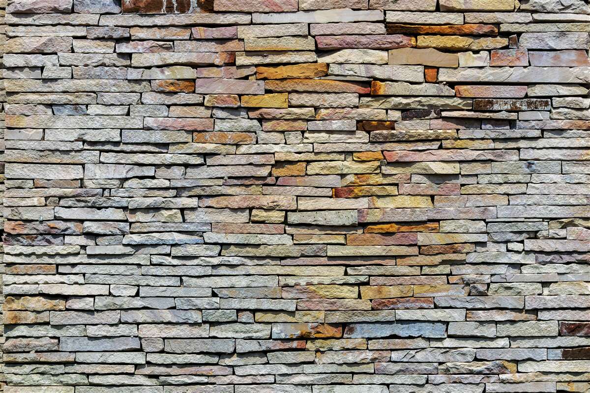 Papier peint Mur recouvert de bandes de pierre