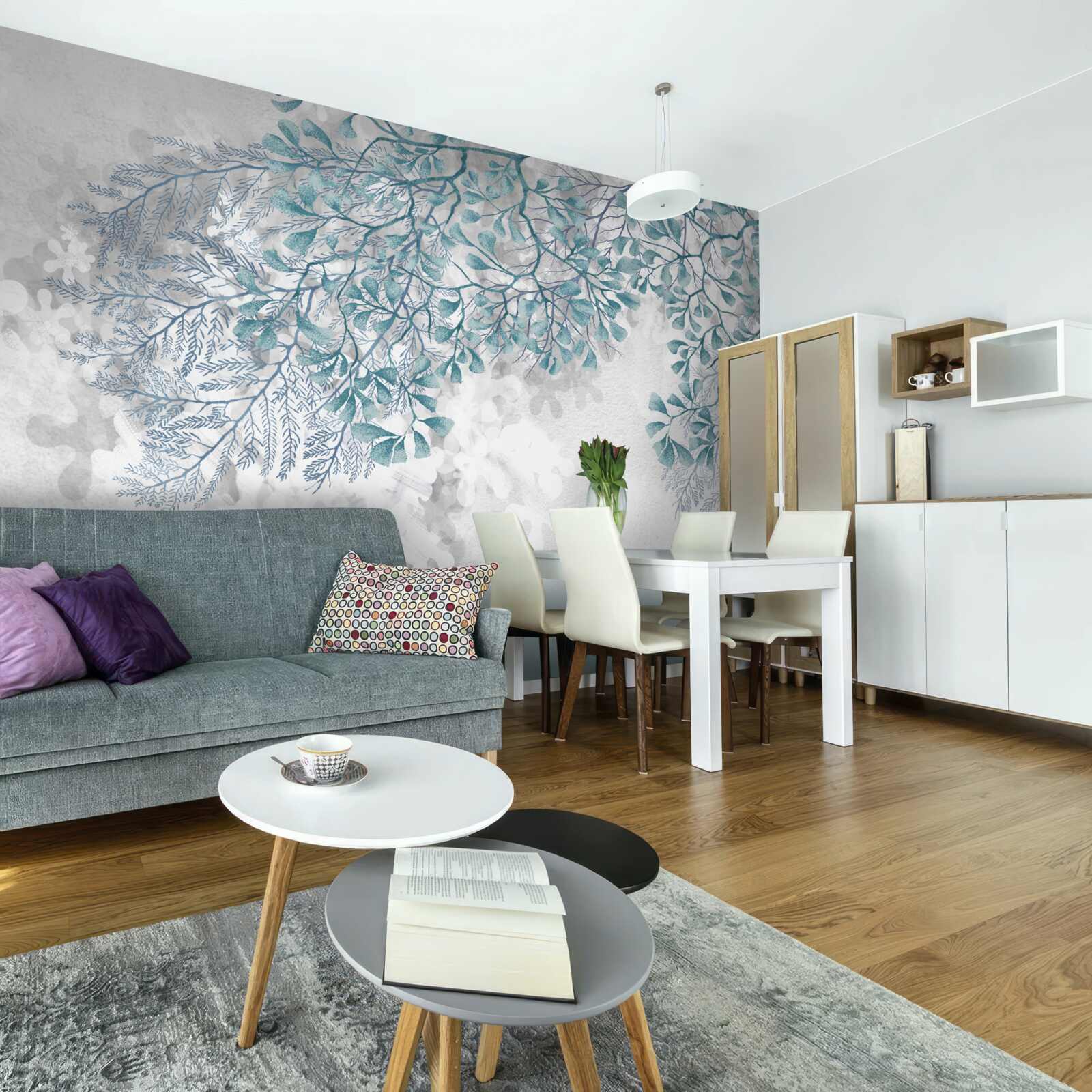 Papier peint les branches avec des feuilles turquoises sont visibles sur un fond clair