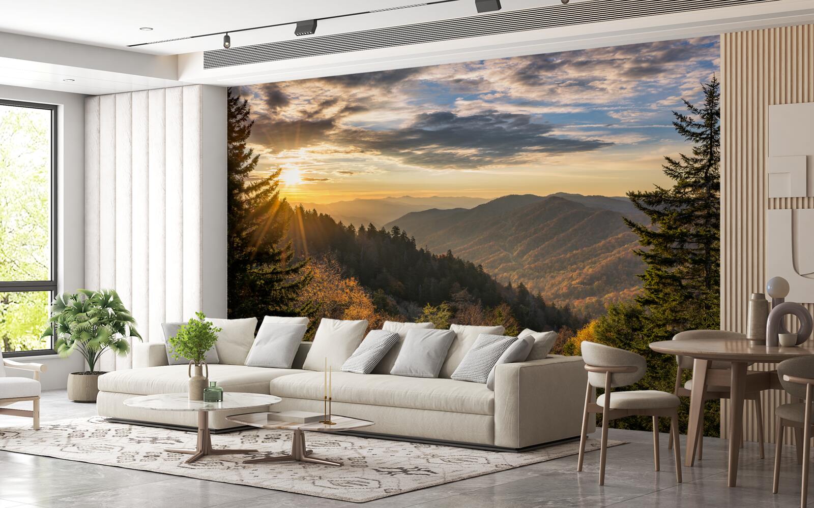 Papier peint le soleil couchant sur les sommets des montagnes