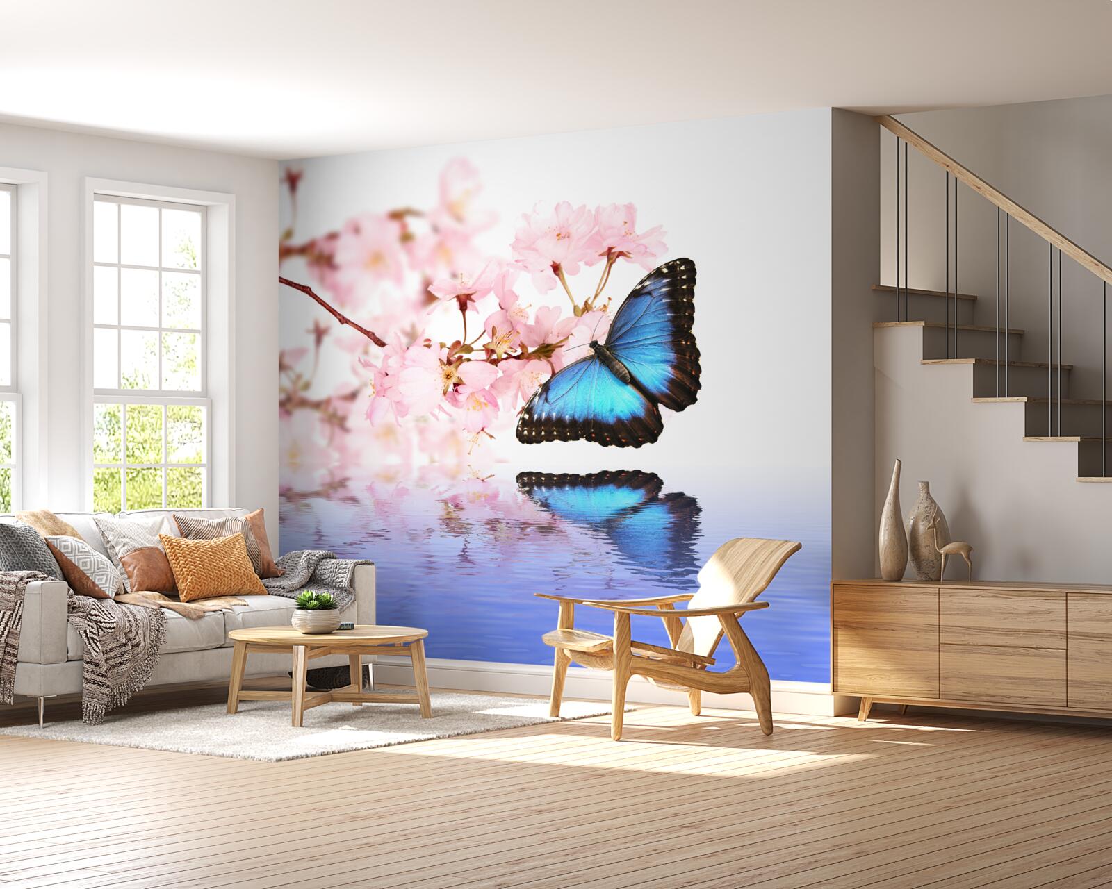 Papier peint un papillon bleu se pose sur un cerisier près de l'eau